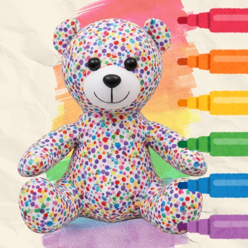 A white bear covered in colourful dots in front of a background of rainbow markers.