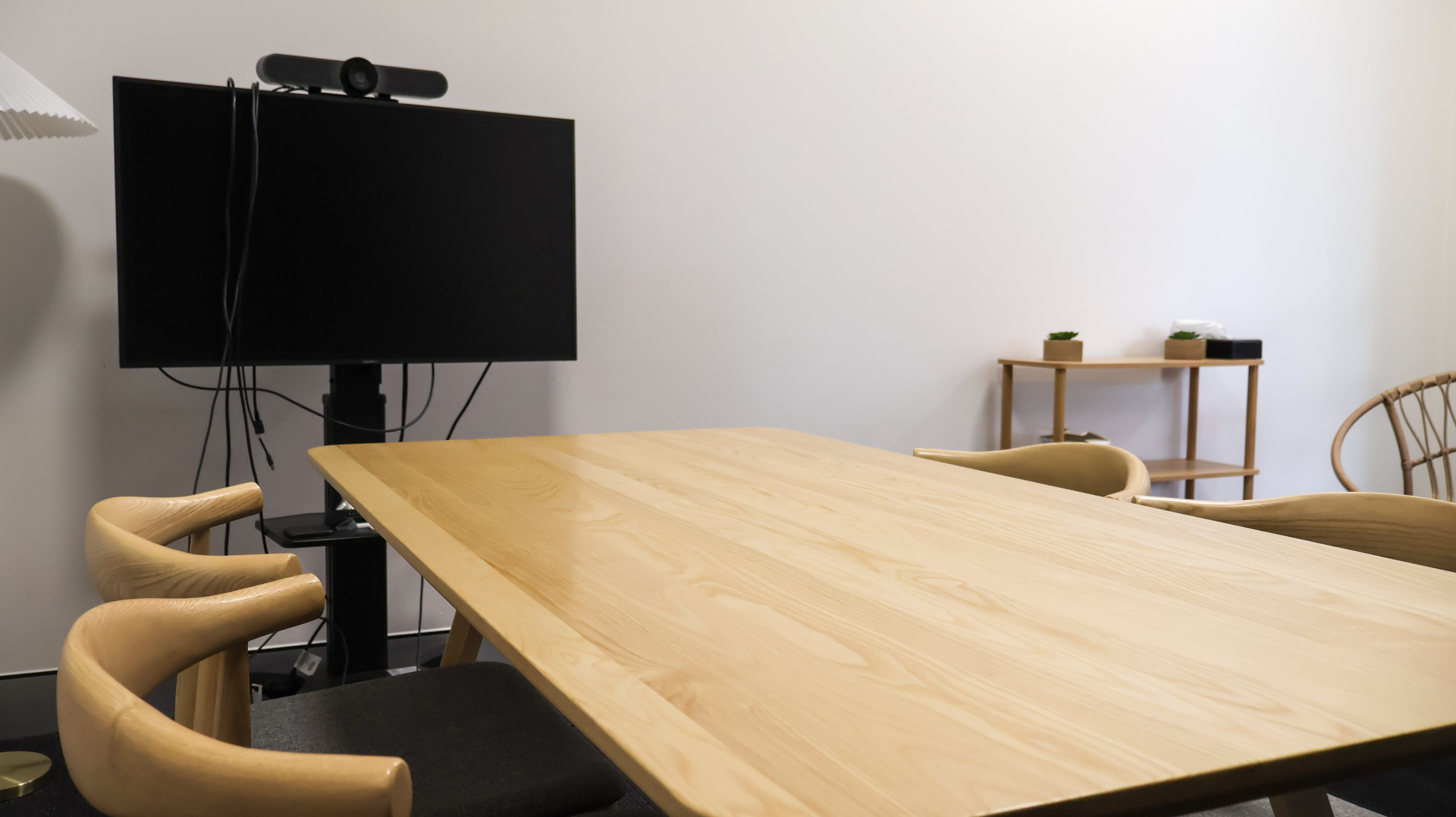 Empty table with four chairs and small smart board