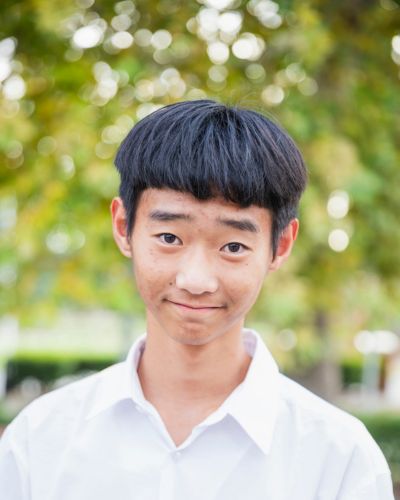 Photo of Leo smiling in front of the Library.