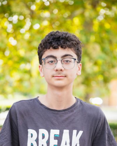 Photo of Sakvan smiling in front of the Library.