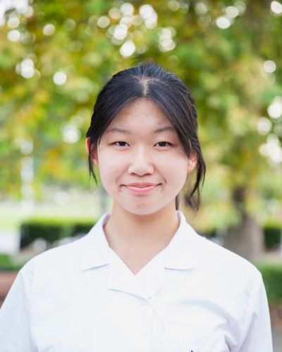 Photo of Yoyo smiling in front of the Library.